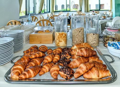 a tray of croissants and other pastries on a table at Hotel Paris in Lido di Camaiore