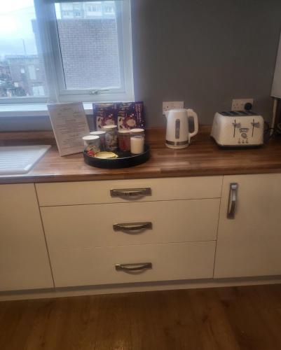 a kitchen counter with a counter top with aounter at Dundas Apartments - Furnished Short Lets in Sunderland