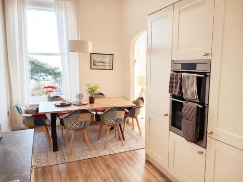 a kitchen and dining room with a table and chairs at Mansion House in Scarborough