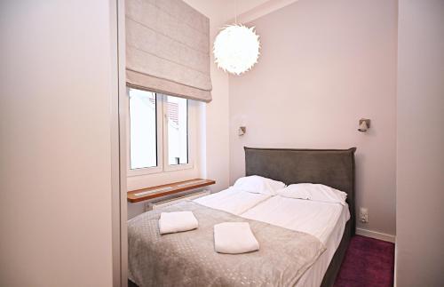 מיטה או מיטות בחדר ב-Salsa Sopot Apartment