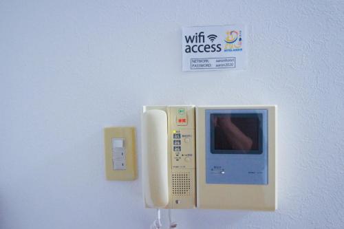 a wall with a phone attached to a wall at HOTEL AARON通天東 in Osaka