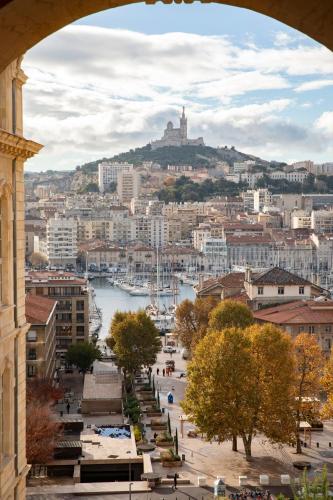 a view of a city from an arch of a building at InterContinental Marseille - Hotel Dieu by IHG in Marseille