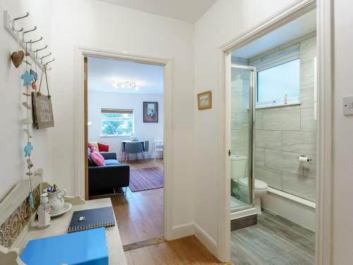 a living room with a glass door leading to a bathroom at Fishermans Rest in Broadstairs