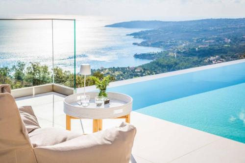 a living room with a table and a view of the ocean at Villa Sorian Kokkino in Vlachata