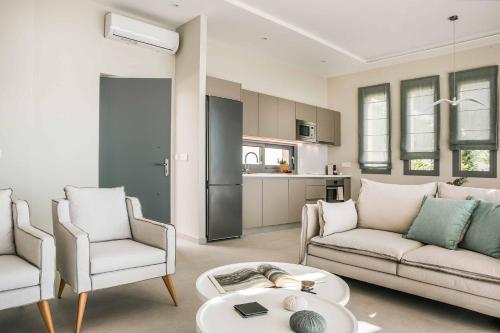 a living room with a couch and chairs and a table at Villa Sorian Kokkino in Vlachata