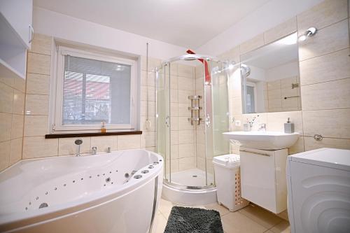 y baño con bañera, lavabo y aseo. en Victus Apartamenty, Apartament Sopot, en Sopot