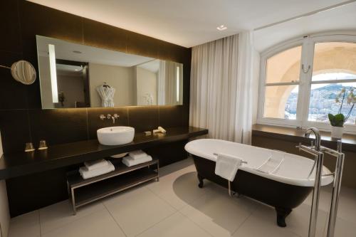 a bathroom with a tub and a sink and a mirror at InterContinental Marseille - Hotel Dieu by IHG in Marseille