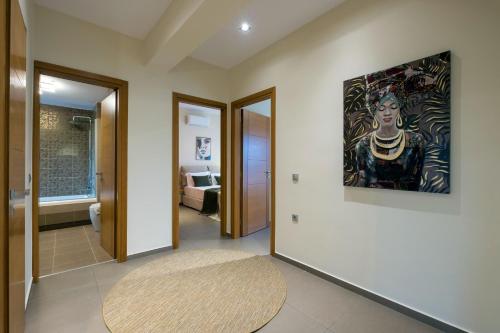 a hallway with a large painting on the wall at Villa Merlin in Galatás