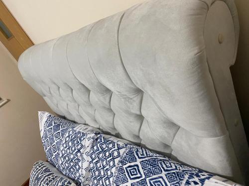 a white pillow on a bed with pillows at Private ensuite room in Birmingham in Birmingham