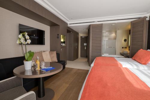 a hotel room with a bed and a table at InterContinental Marseille - Hotel Dieu by IHG in Marseille
