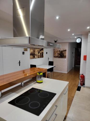 a kitchen with white cabinets and a counter top at Amber Hostel Szlak in Krakow