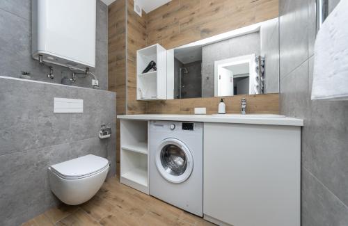 a bathroom with a washing machine and a sink at MYFREEDOM Апартаменти, Теремки, ВДНГ in Kyiv