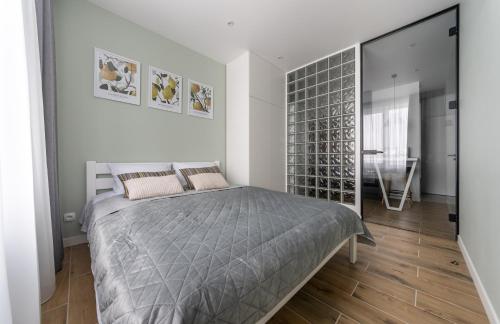 a bedroom with a bed and a walk in closet at MYFREEDOM Апартаменти, Теремки, ВДНГ in Kyiv