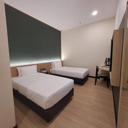 Ένα ή περισσότερα κρεβάτια σε δωμάτιο στο Urban Inn, Alor Setar