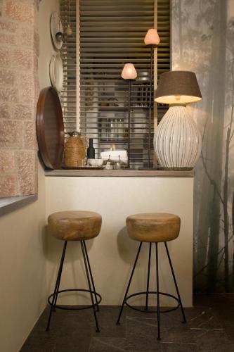 a kitchen with two stools in front of a counter at Alodia in Alquézar