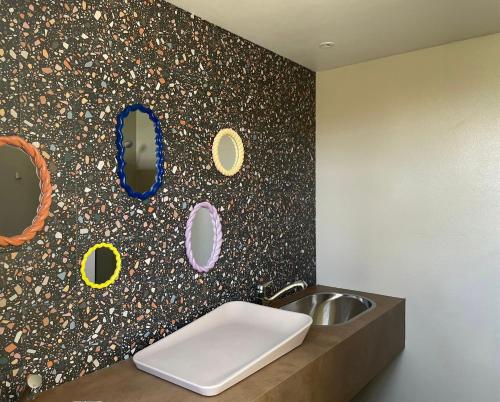 a bathroom with a sink and a wall with mirrors at Camping de Vliert in Bunnik