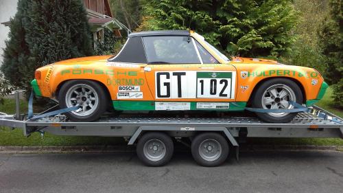 an orange car on the back of a trailer at Ferienwohnung Blum in Antweiler