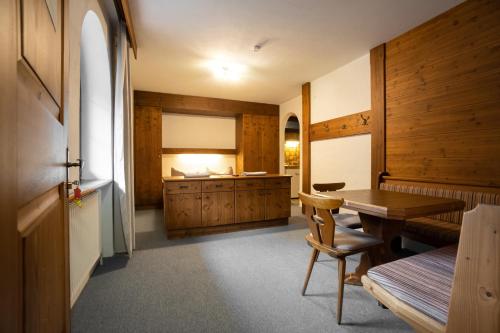 a kitchen with wooden cabinets and a wooden table at MY HIAS Apartment in Gries im Sellrain