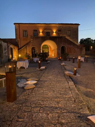 a stone pathway leading to a building with candles on it at Feudo Bauly in Palazzolo Acreide