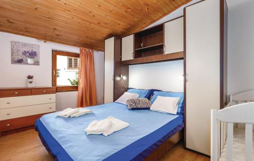 a bedroom with a blue bed with towels on it at House Antoine in Kras