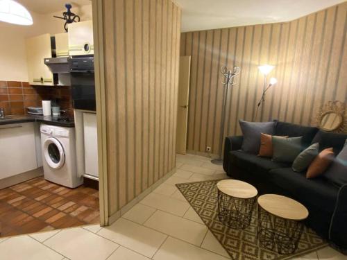 a living room with a couch and a table at Seine & Eiffel Flat Beaugrenelle Area in Paris