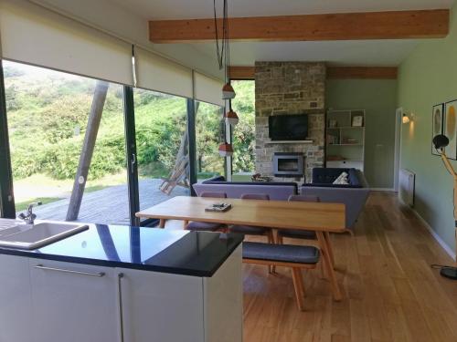 a kitchen and living room with a couch and a table at Yorkshire Dales Lodge 1 by Together Travel - 3-Bed Ensuite Retreat in Richmond