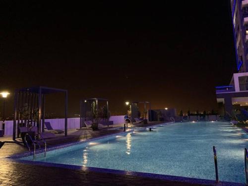 een groot zwembad in de nacht bij Cheras Romantic Studio House with free Netflix and wifi in Kajang