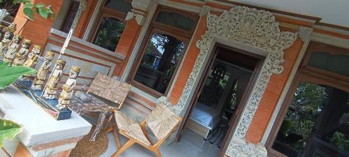 a pair of chairs sitting outside of a building at Chakra Living Ubud in Ubud