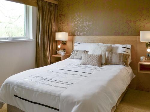 a large white bed in a room with a window at Hazel in Thornbury