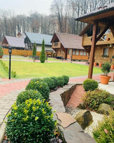 a garden with a stone walkway in front of a building at Приватна садиба Шаянське джерело in Shaian