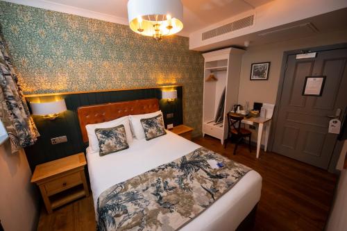 a bedroom with a large bed and a table at Riverside Hotel by Chef & Brewer Collection in Burton upon Trent