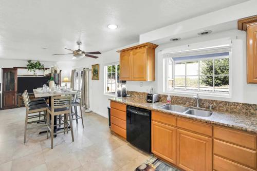 a kitchen with wooden cabinets and a table with chairs at Large Family Home - Only 20 mins from Disneyland in Fullerton