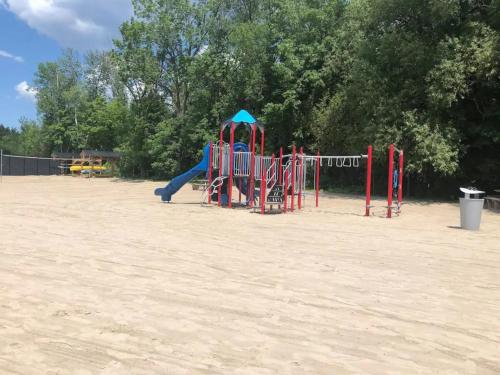 a playground in the sand in a park at PET FRIENDLY CONDOS at FRIDAY HARBOUR in Innisfil