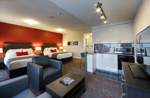 een hotelkamer met 2 bedden en een keuken bij Liberty Suites in Thornhill