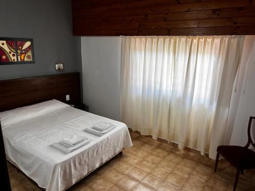 Una cama o camas en una habitación de Hotel Fariña