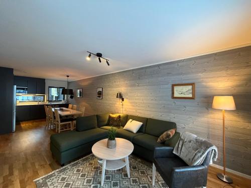 a living room with a couch and a table at Funäs Fjällby Funäsdalen in Funäsdalen