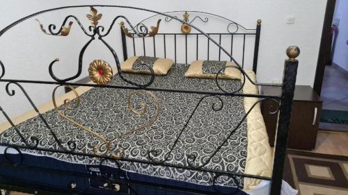 a black and white bed with pillows on it at Villa Jelena Mavrovo in Mavrovo