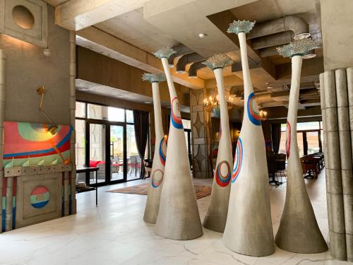 a lobby with a bunch of vases in a room at Brim Hotel in Tbilisi City