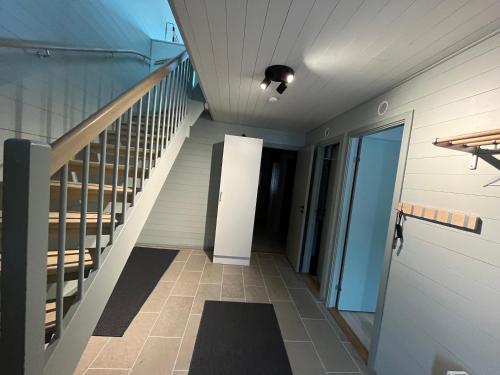 a hallway of a house with a staircase and a door at Kåvan Townhouse Funäsdalen in Funäsdalen