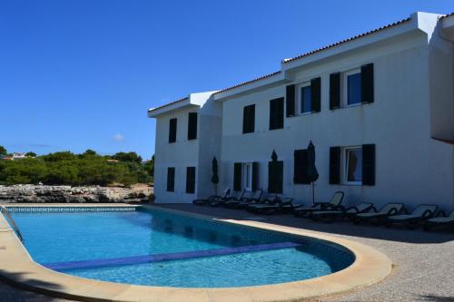 a swimming pool in front of a building at Apartamento Tramuntana 3 in Cala Blanca