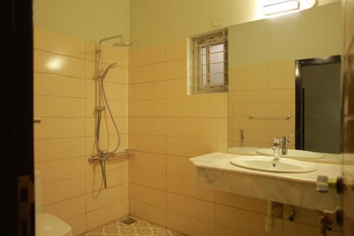 a bathroom with a sink and a shower at Sunset BnB in Karachi