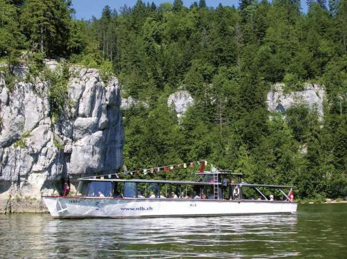 a group of people riding on a boat on the water at Appartement Douces heures avec parking couvert privé in Le Locle