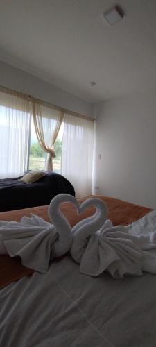 a heart made out of towels on a bed at Anubis in Merlo