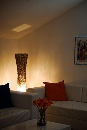 a living room with a couch and a light at Branco Suites - Rooms & Holiday Apartments in Santa Maria
