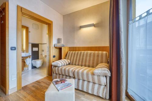 a living room with a couch and a bathroom at MOTA hotel in Livigno