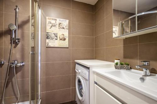ein Badezimmer mit einer Waschmaschine und einem Waschbecken in der Unterkunft Moder in Istanbul