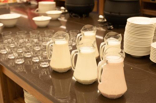 a group of glasses and plates on a table at ARDEN PALACE Medical Resort & SPA in Satanov