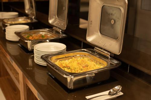 a buffet with trays of food on a table at ARDEN PALACE Medical Resort & SPA in Satanov