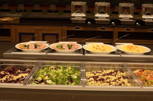 a buffet line with many different types of food at ARDEN PALACE Medical Resort & SPA in Satanov