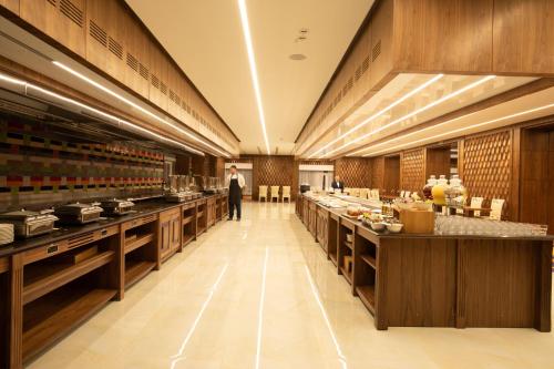 a restaurant with long counters and a man in the distance at ARDEN PALACE Medical Resort & SPA in Satanov